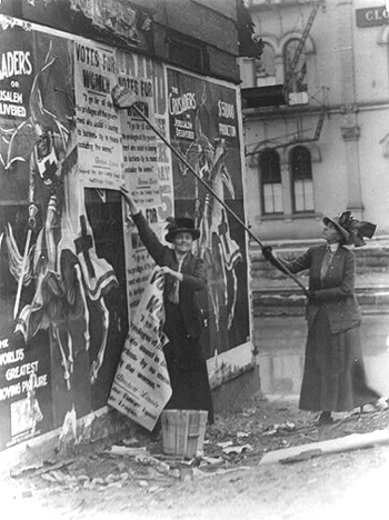 Louise Hall and Susan FitzGerald putting up posters